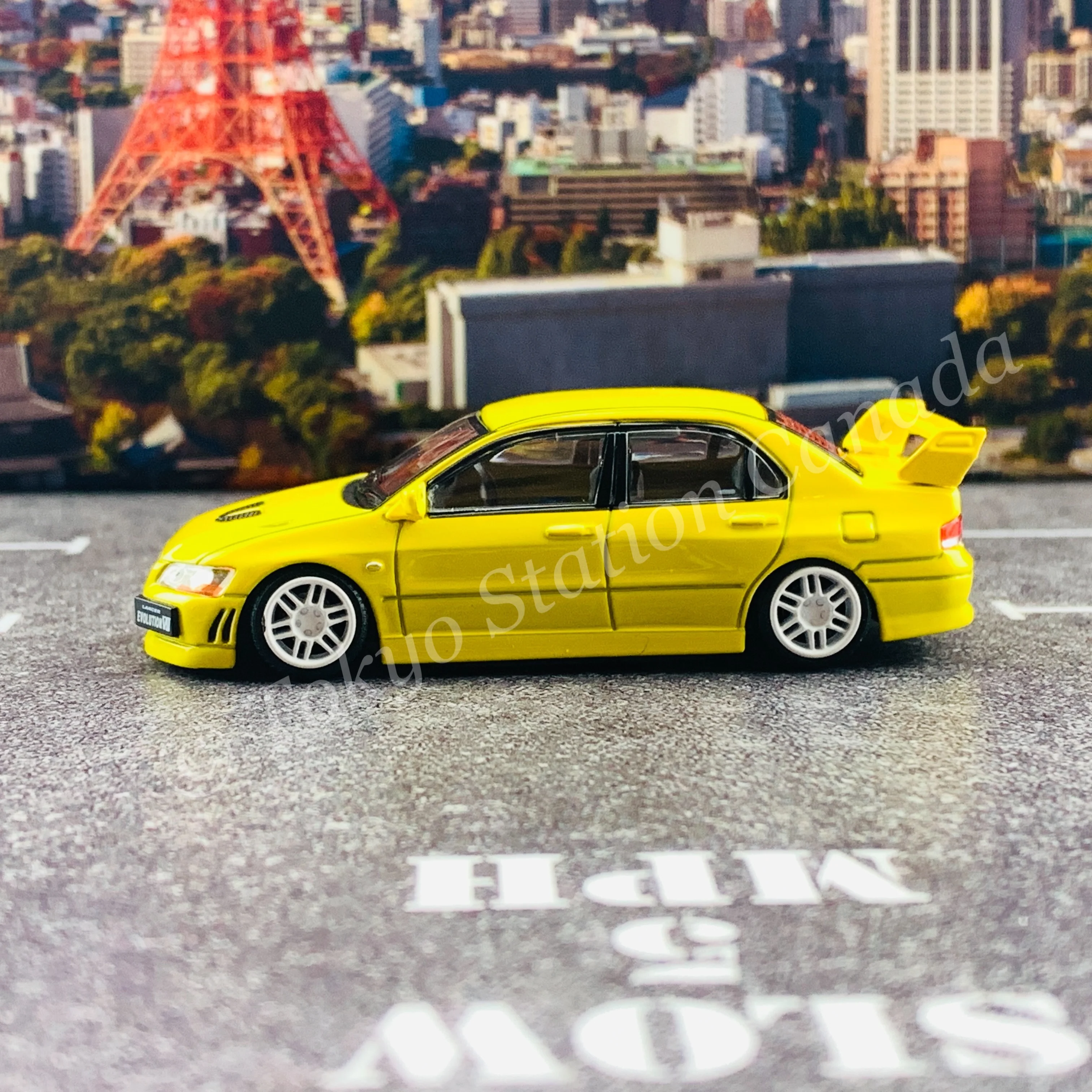 BM CREATIONS JUNIOR 1/64 Mitsubishi Lancer Evolution VII YELLOW RHD with Extra Wheel Set and Lowering Parts 64B0084 - Image 6