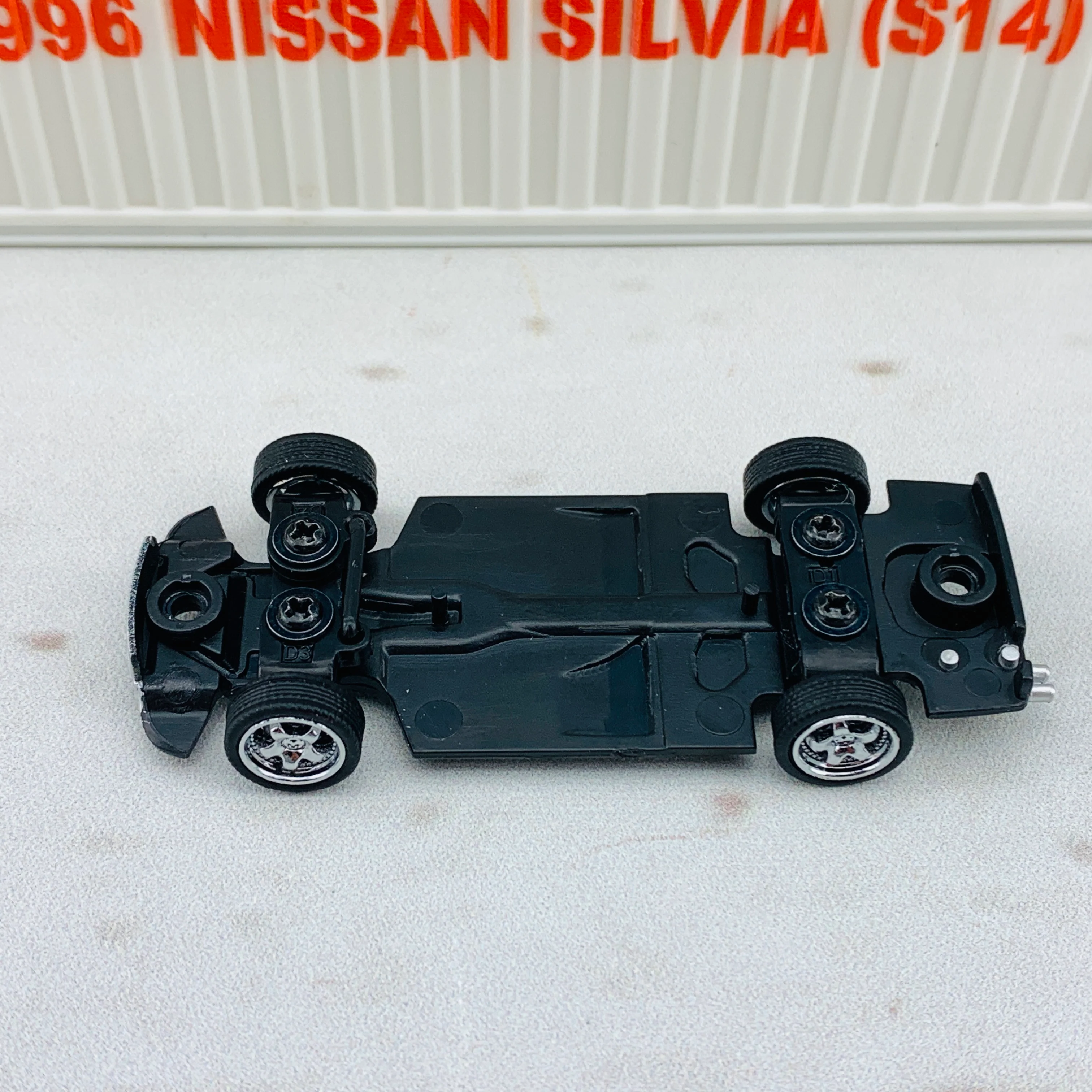 BM Creations JUNIOR 1/64 Nissan Silvia S14 Black RHD with Extra Wheels, Lowering Parts and Container Display 64DM64001 - Image 9