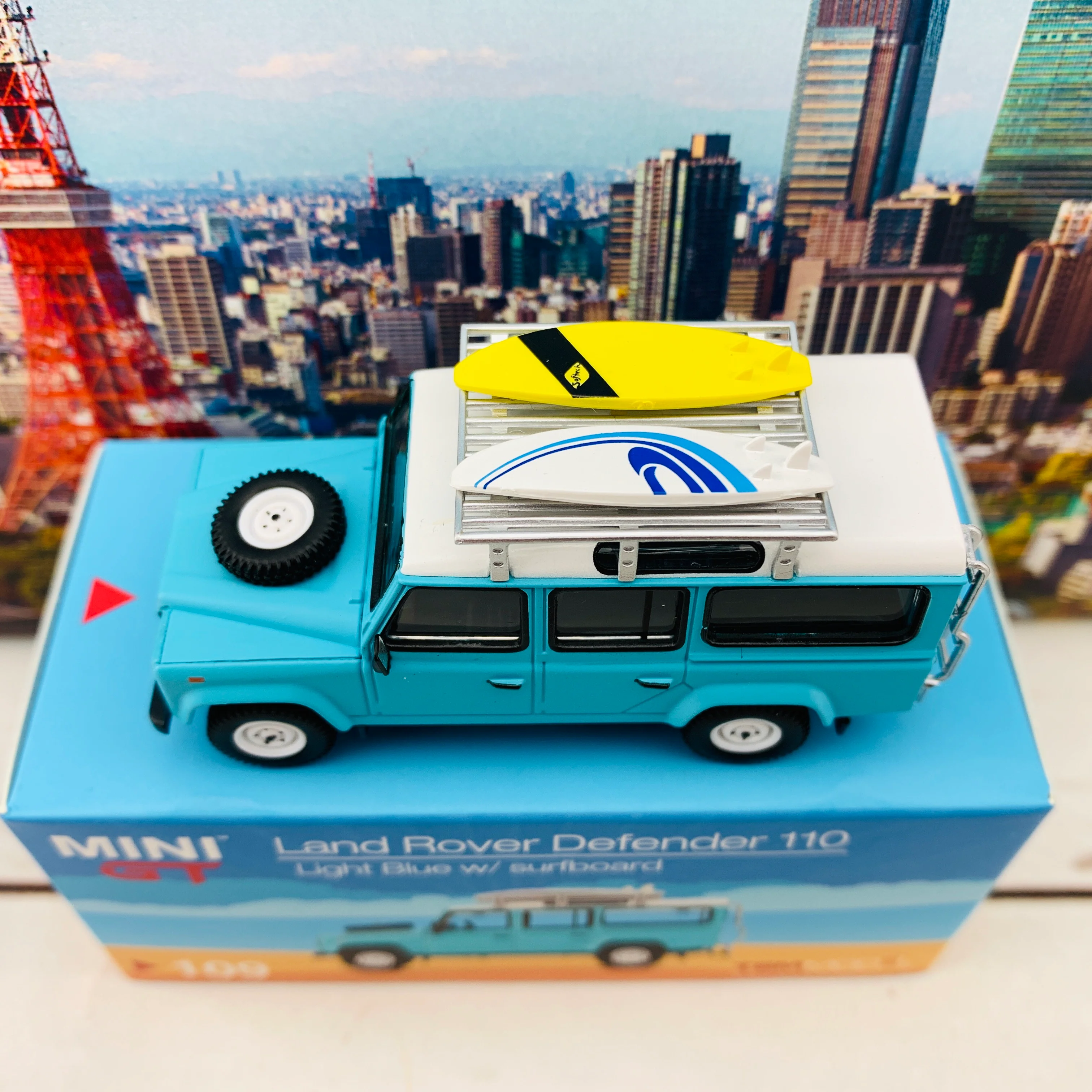MINI GT 1/64 Land Rover Defender 110  Light Blue w/ Surfboard RHD MGT000109-R - Image 2